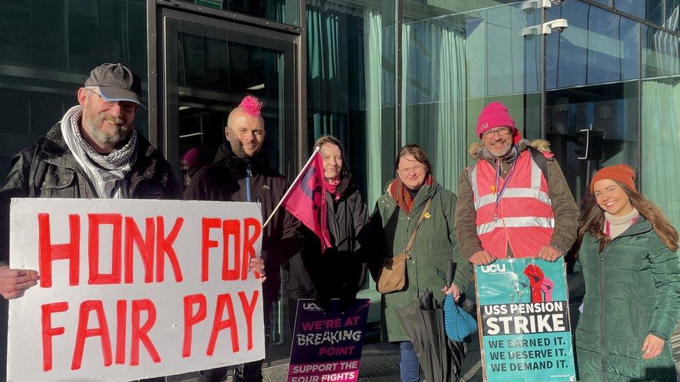 Lecturers gather outside Ulster University in Belfast