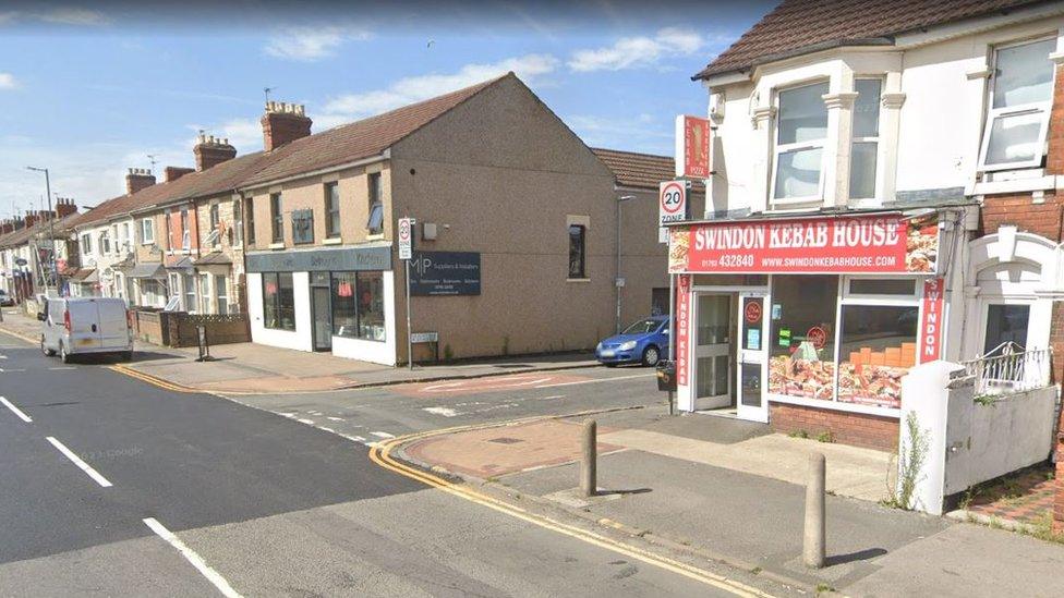 The corner of Manchester Road and Gladstone Street. There is a kebab shop and a pub on the opposite corner.