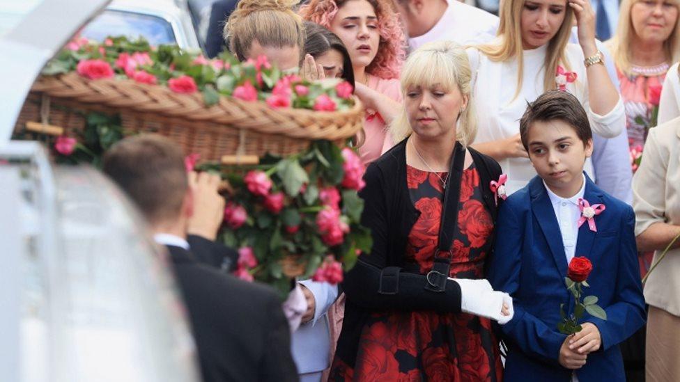 Mother Lisa Roussos and brother Xander with the coffin of Saffie Roussos