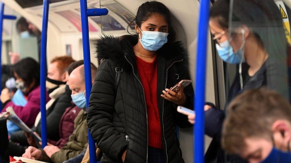 Woman wearing mask on the Tube