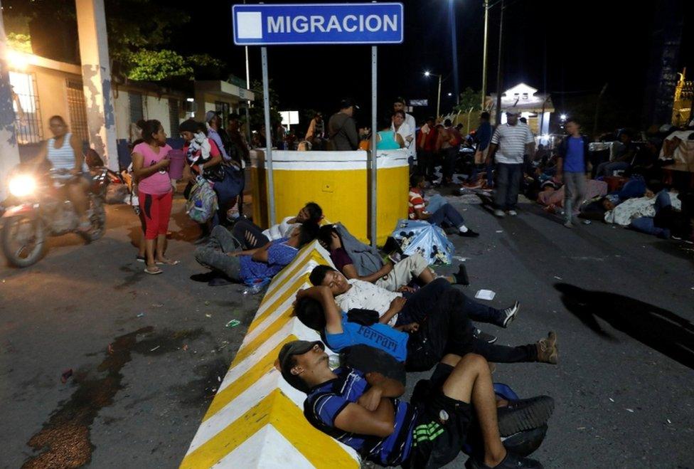 Honduran migrants rest at the checkpoint between Guatemala and Mexico, in Tecun Uman, Guatemala