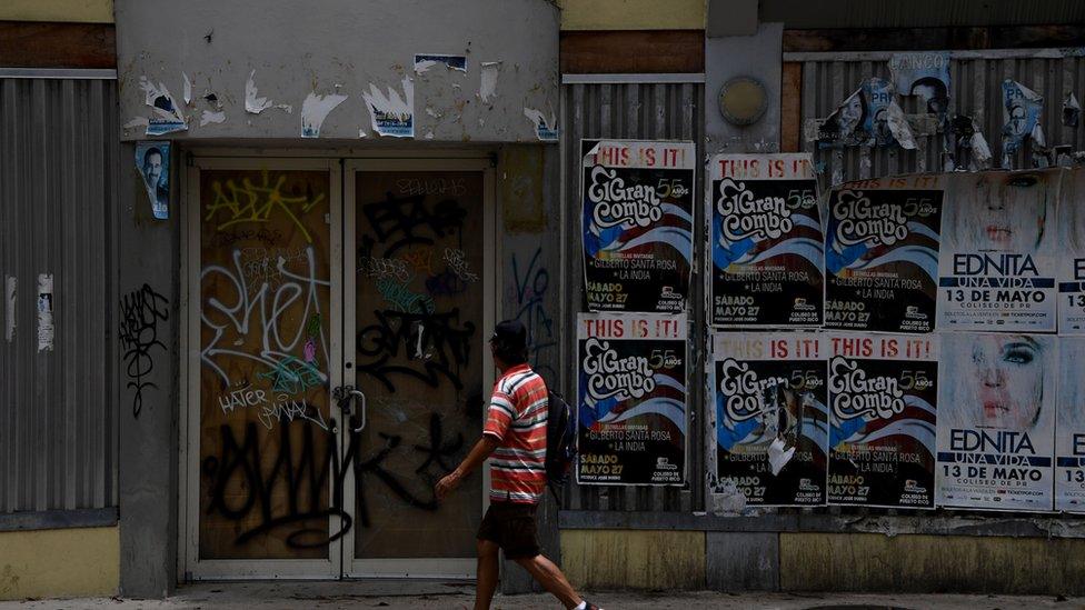 Puerto Ricans on a major shopping street are pictured on May 16, 2017 in San Juan, Puerto Rico,