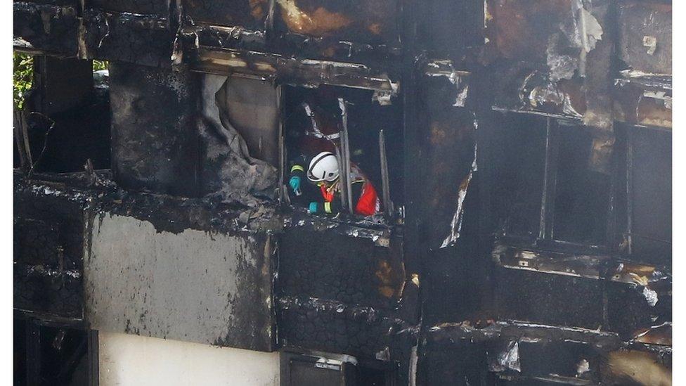 A firefighter photographs damage