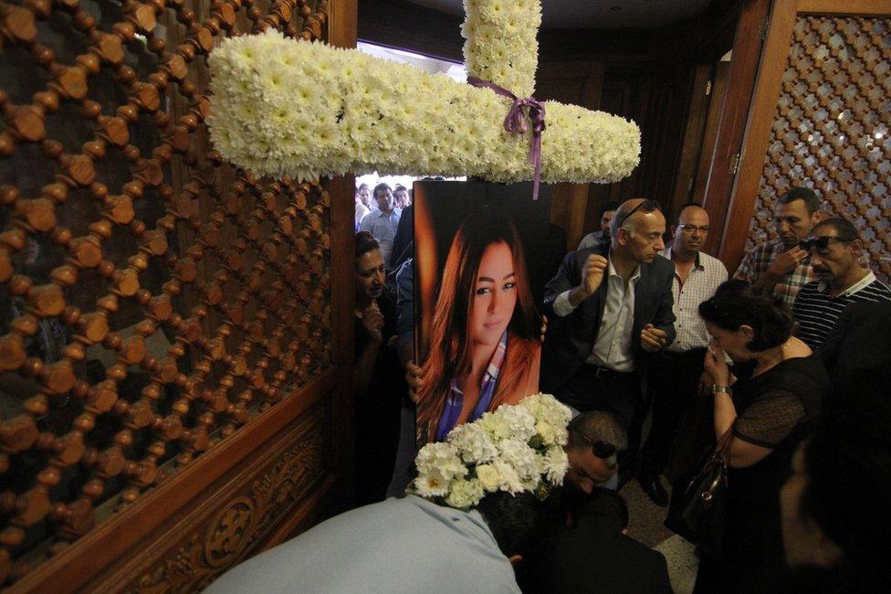 Relatives and friends of air hostess Yara Hani (portrait) attend a church service in Cairo, 21 May