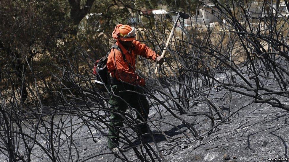 An inmate checks for hotspots at the Jerusalem fire