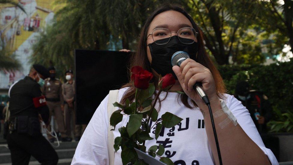 Political activist Panusaya "Rung" Sithijirawattanakul speaks outside the Constitutional Court of Thailand in Bangkok on November 10, 2021.