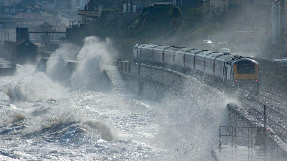 train-going-past-water.