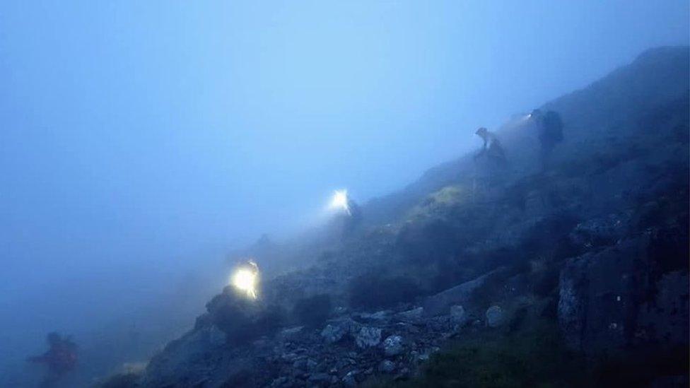 Walkers walk down hill spaced out