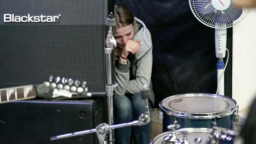 Lyudmila at her late fiancé's first band rehearsal after his death