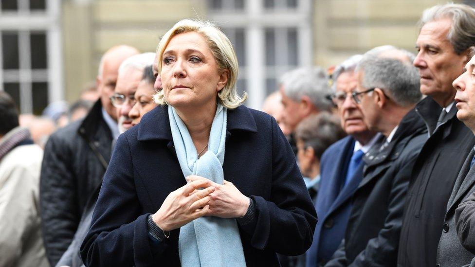 French presidential election candidate for the far-right Front National (FN) party, Marine Le Pen (L) attends a ceremony honouring the policeman killed by a jihadist in an attack on the Champs Elysees, on 25 April 2017 at the Paris prefecture building