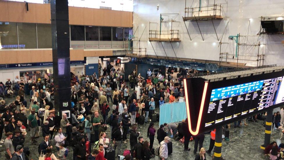 Crowds standing in Euston station