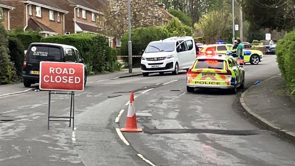 A road closed sign in Bristol with a police car