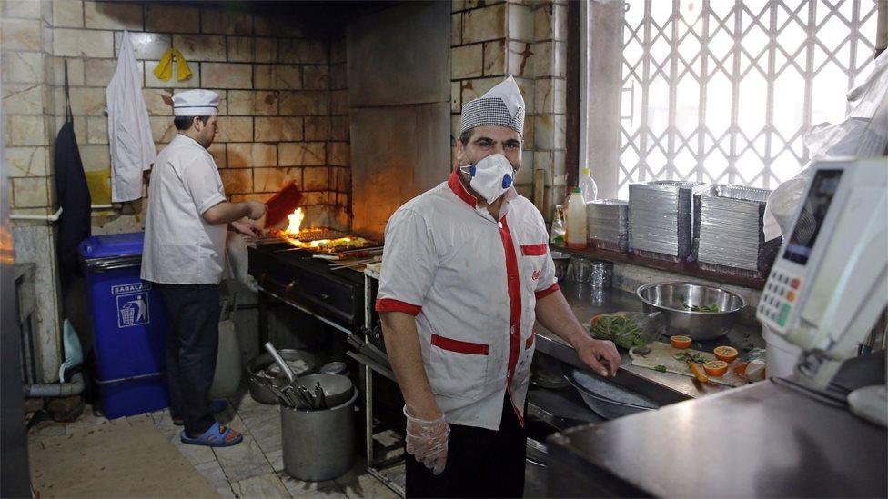 A chef wears a face mask at a restaurant in Tehran, Iran