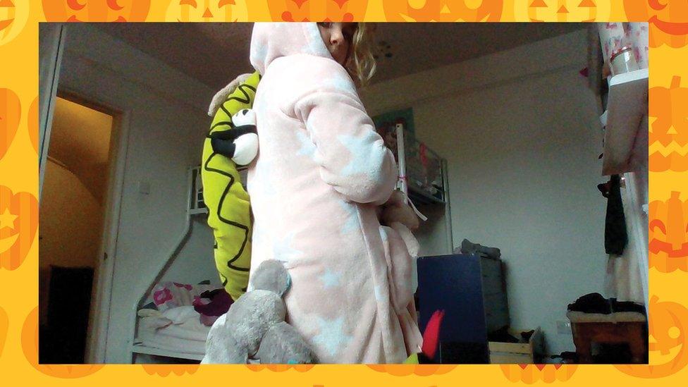girl-dressed-in-onesie-with-animals