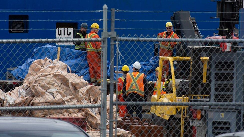 Debris from the Titan are covered in tarp