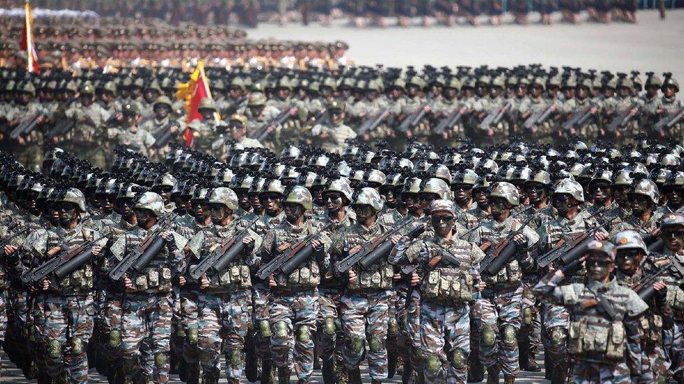 Rows and rows of North Korean soldiers, stretching as far as the eye can see, march in full tactical gear