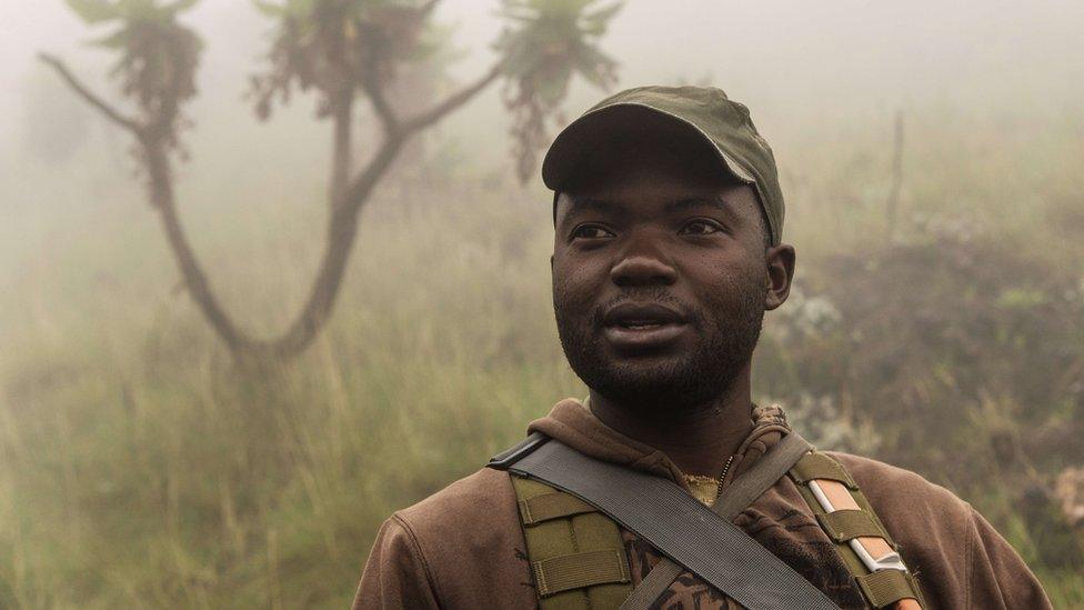 A ranger in the morning mist walks down Mount Nyiragongo in Virunga National Park