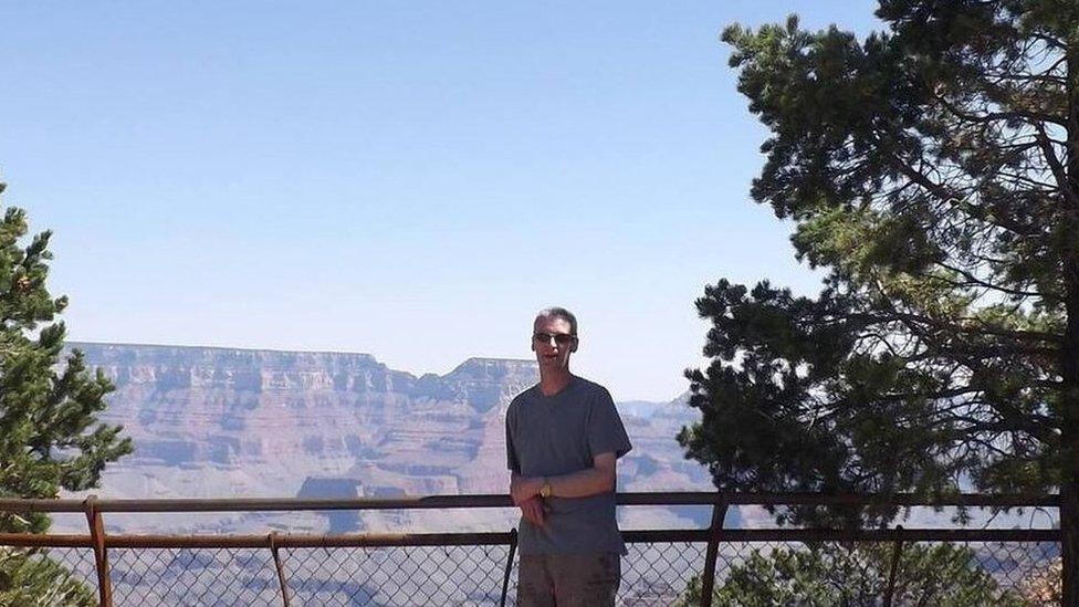 Portrait of Jason lock in front of a mountain