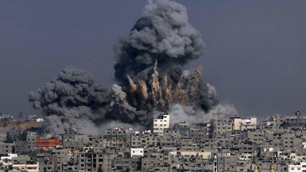 Clouds of smoke billow into the air following an Israeli military strike in Gaza City on 29 July 2014