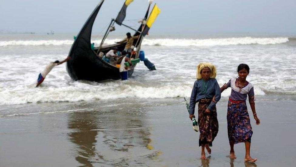 Rohingya refugees walk to the shore after crossing the Bangladesh-Myanmar border by boat through the Bay of Bengal in Teknaf, Bangladesh, September 7, 2017.