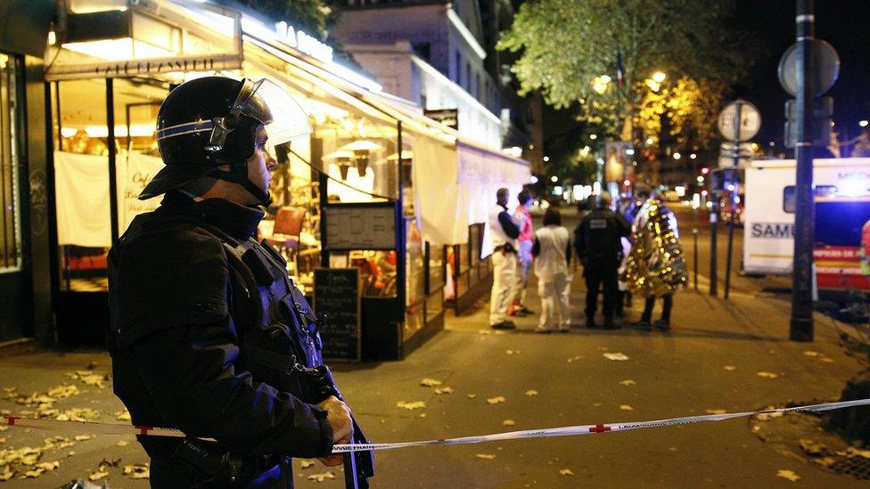 Policeman with gun and tape near Bataclan