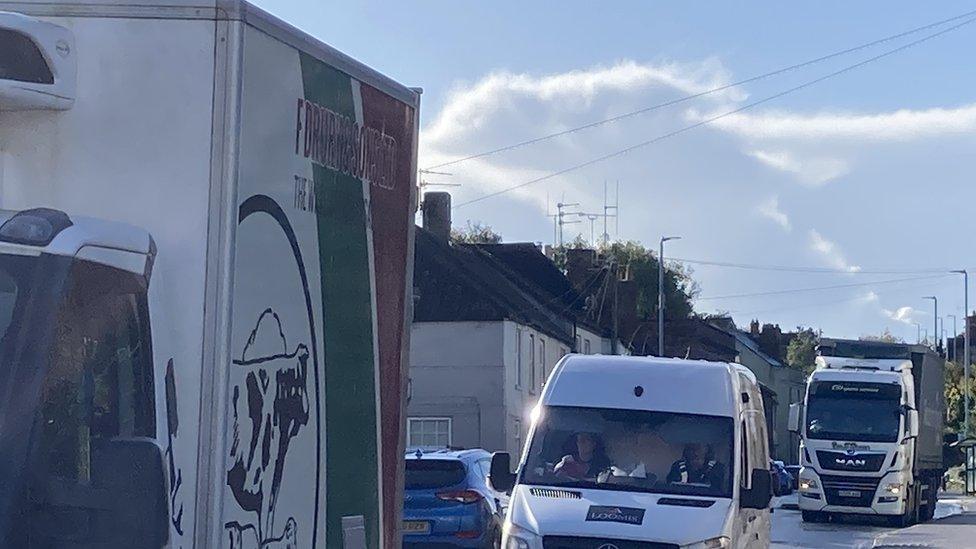 A shot of the A350 in the centre of Westbury with a large lorry, van and other traffic.