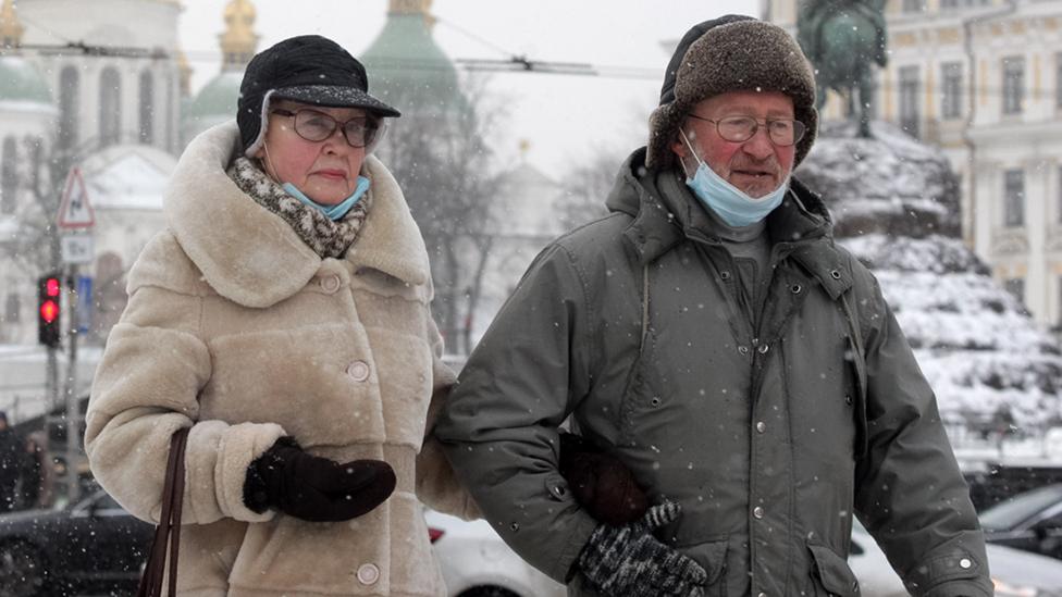 A couple walks in front of St Sophia's Cathedral in the centre of Kyiv, Ukraine on 21 January 2022