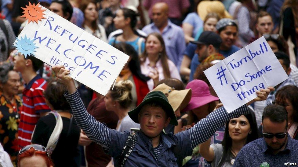 A protester demands better treatment of migrants in Australia