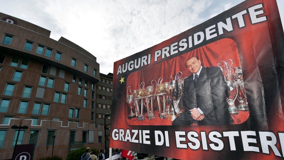 "All the best, president - thanks for being there", a banner reads outside the hospital in Milan where Mr Berlusconi underwent the operation