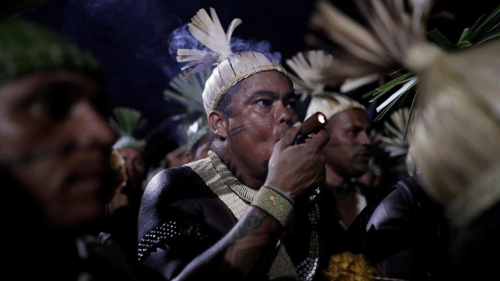 Indigenous men take part in a protest to defend indigenous land and cultural rights