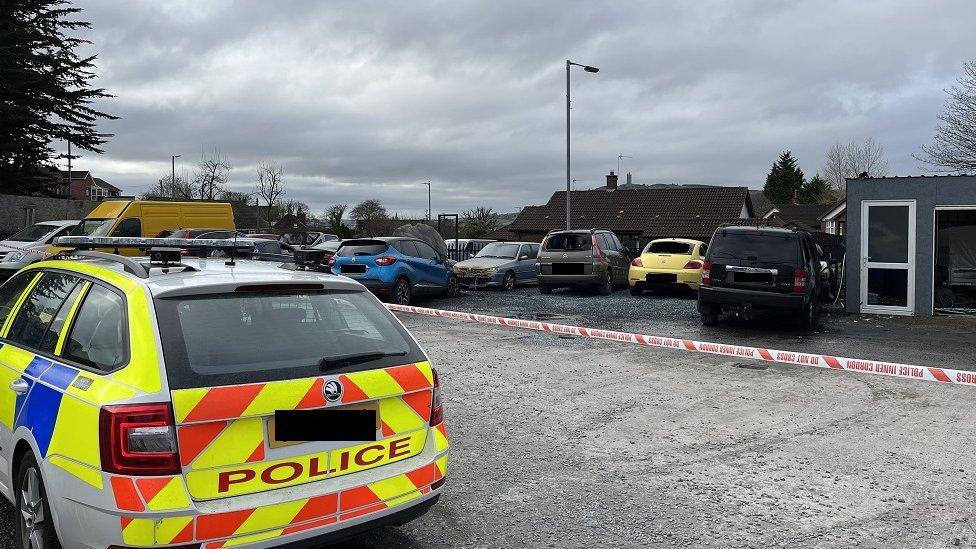 A police car and several damaged cars