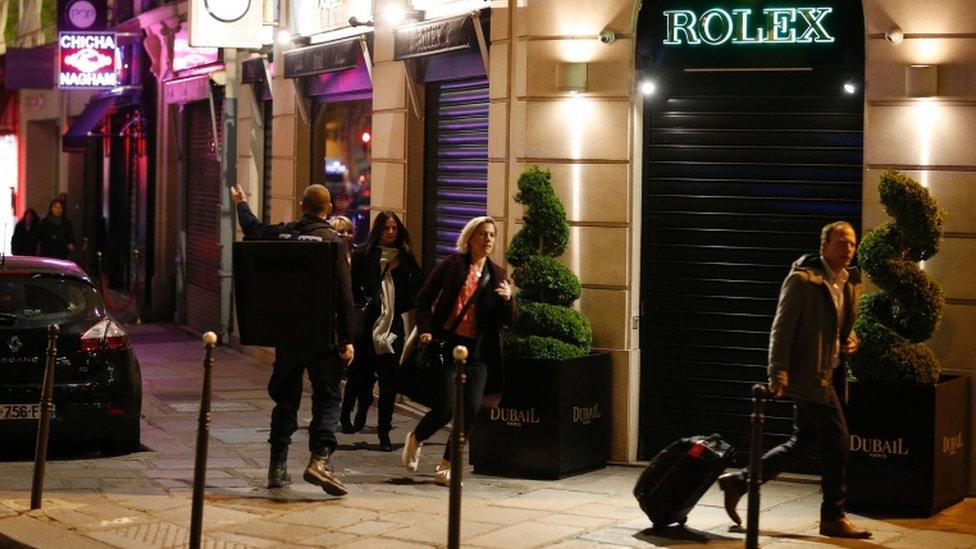 People hurry away from the scene of the Champs-Elysses shooting, Paris, 20 April 2017