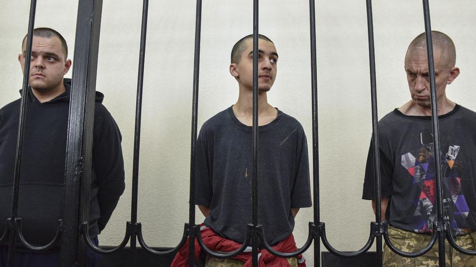 British citizens Aiden Aslin (L) and Shaun Pinner (R) and Moroccan Saaudun Brahim (C) attend a sentencing hearing at the Supreme Court of the self-proclaimed Donetsk People's Republic (DPR) in Donetsk, eastern Ukraine, 09 June 2022 (issued 10 June 2022).