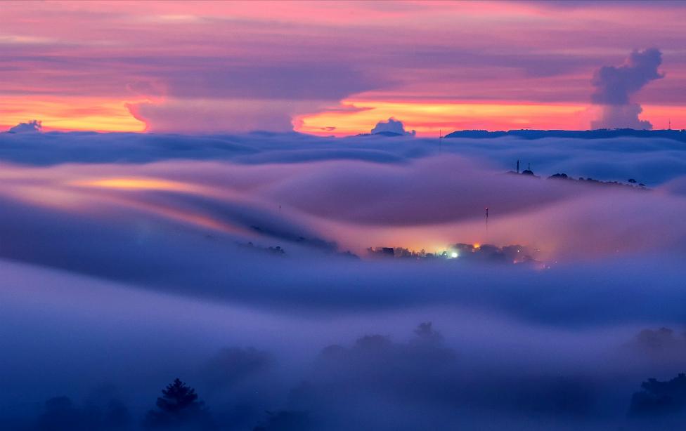 A foggy landscape backlit by the sun