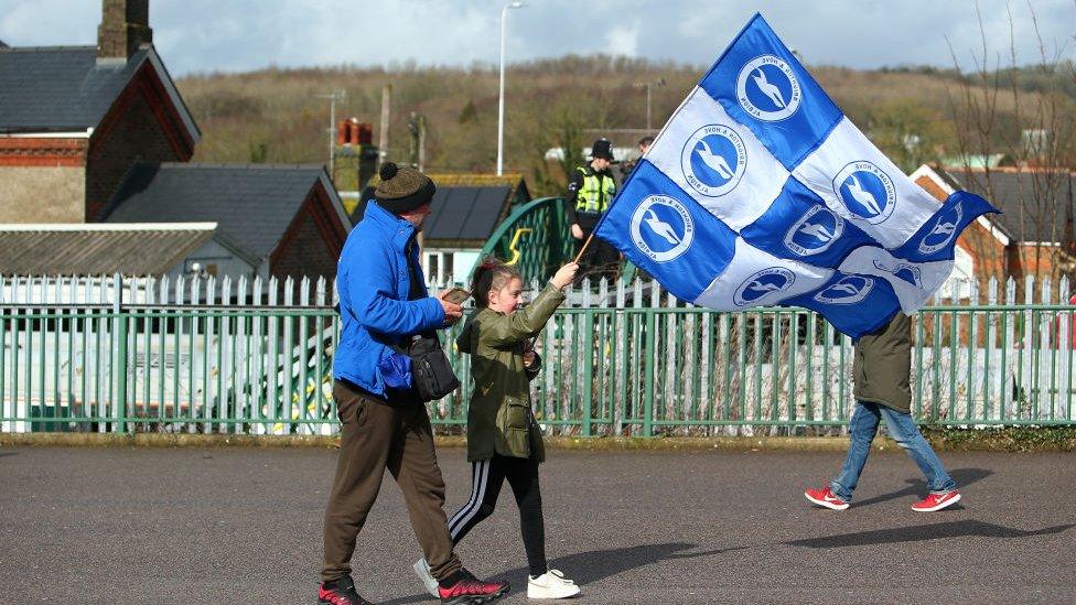 Girl-carrying-Brighton-Flag.