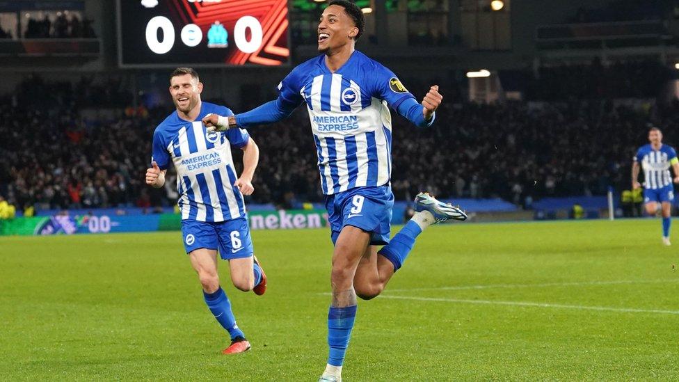 João Pedro celebrating his goal v Marseille with James Milner chasing him