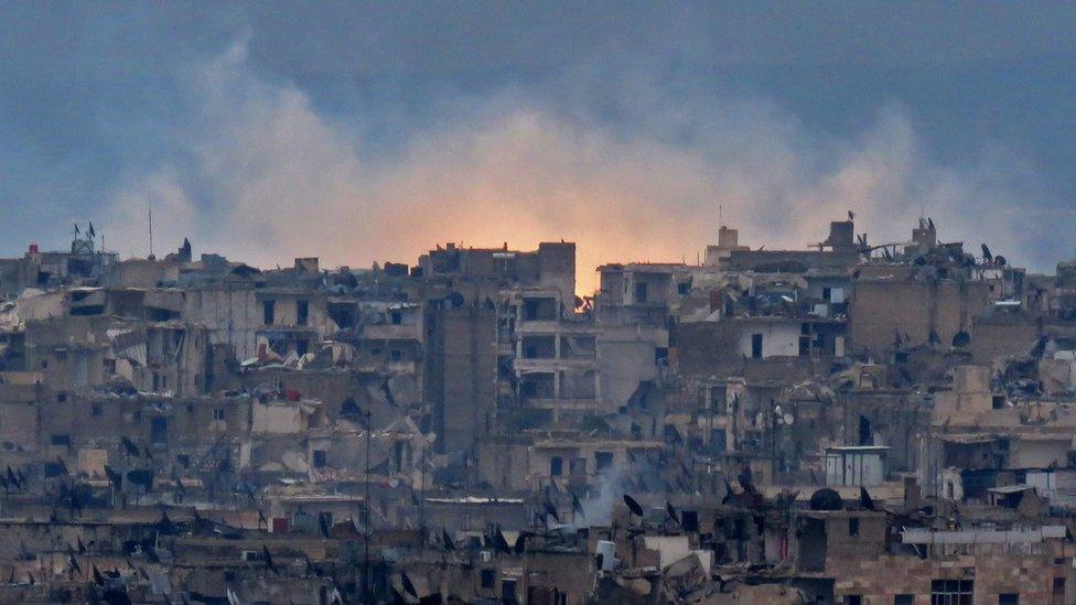 A general view shows smoke and flames rising from buildings in Aleppo"s southeastern al-Zabdiya neighbourhood following government strikes on December 14, 2016