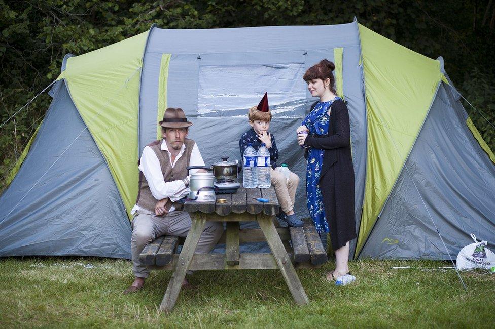 Portrait of a family in front of a tent