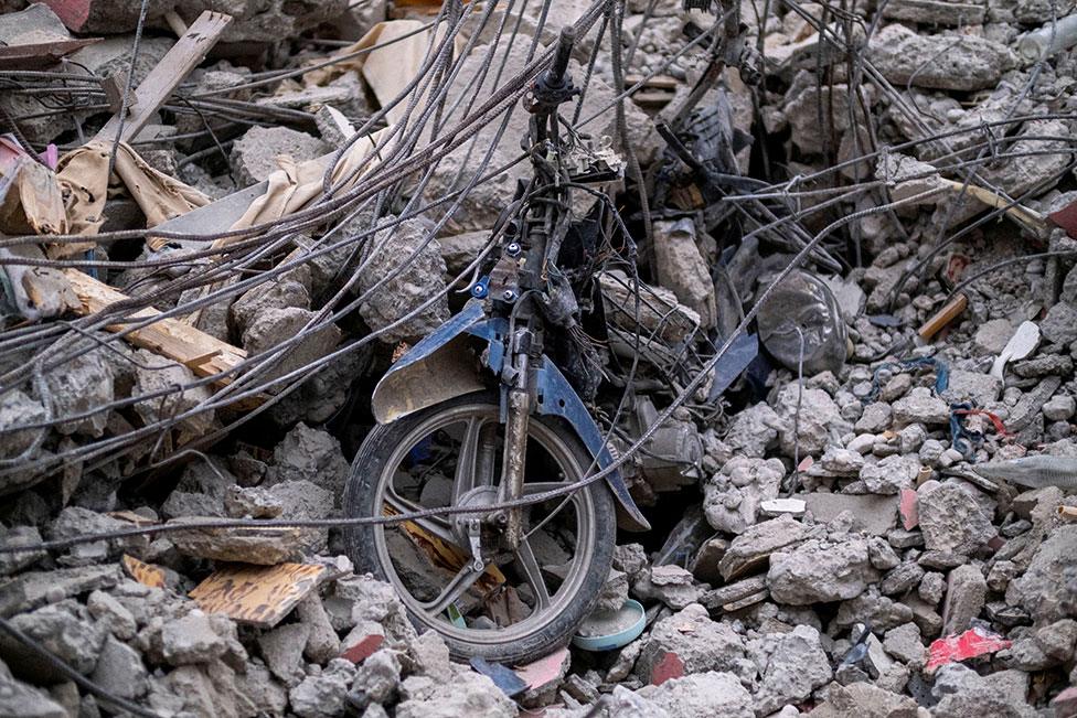 Parts of a motorcycle are seen in the rubble of a destroyed hotel in Les Cayes, Haiti on 16 August 2021