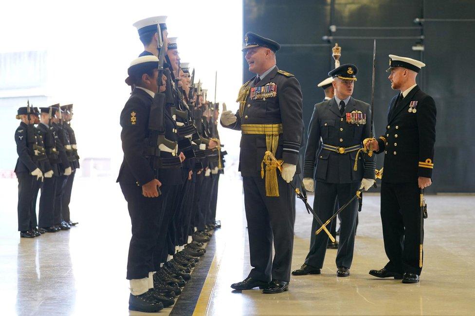 Air Marshall Harvey Smyth inspects personnel from 809 Naval Air Squadron during the commissioning ceremony at RAF Marham