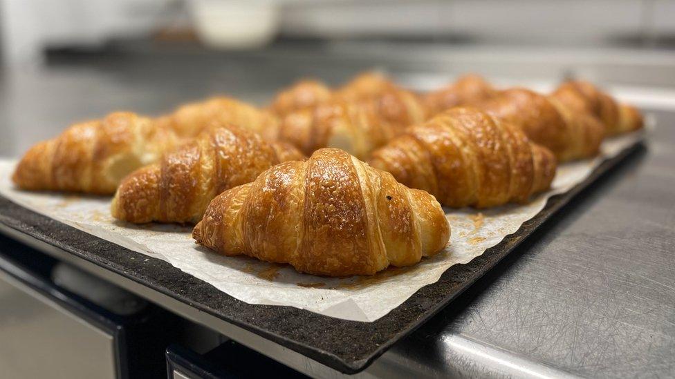 Croissants sit on a tray ready for sale at a bakery in Paris