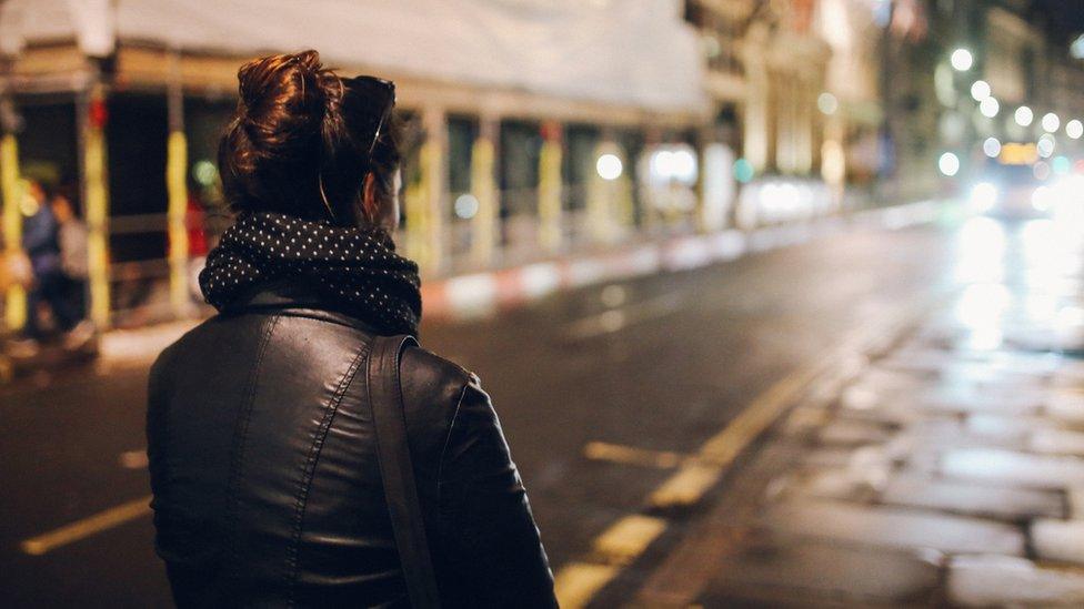 woman walking at night