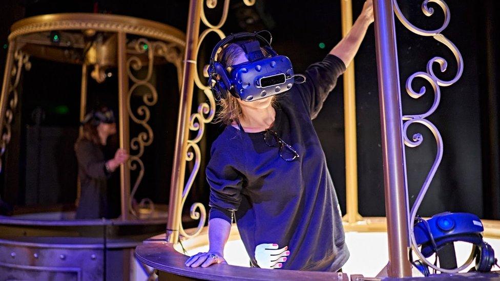 A person in the War of the Worlds experience with a virtual reality headset