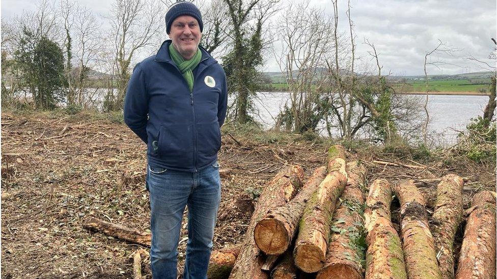 Tim McCaul pictured with felled trees on banks of foyle