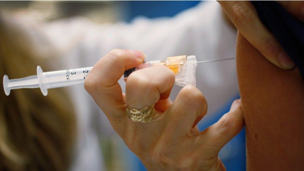 A HPV vaccine being administered to a patient via injection