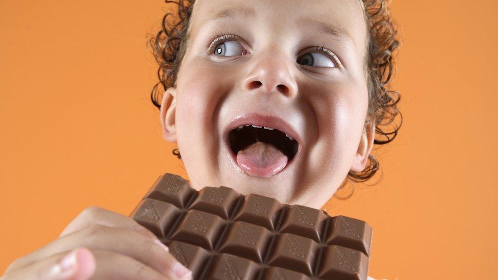 Boy about to eat chocolate.