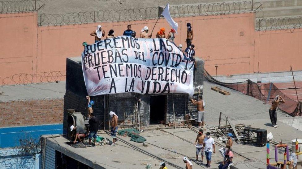 Inmates at the Lurigancho jail hold a banner reading: "We want Covid-19 tests, we have the right to life"