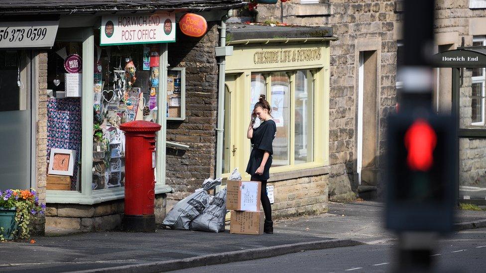 Post office worker retrieving mail in Whaley Bridge