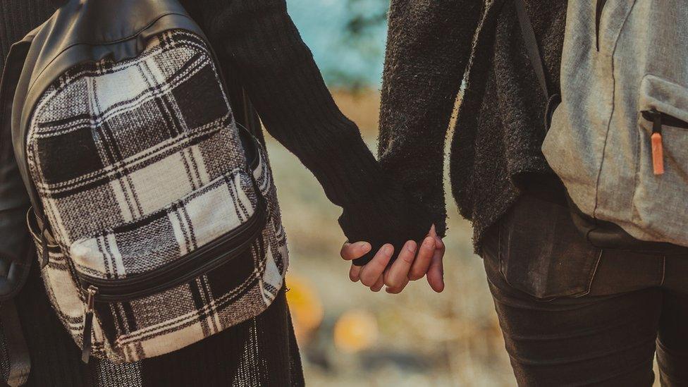 Gay school pupils hold hands