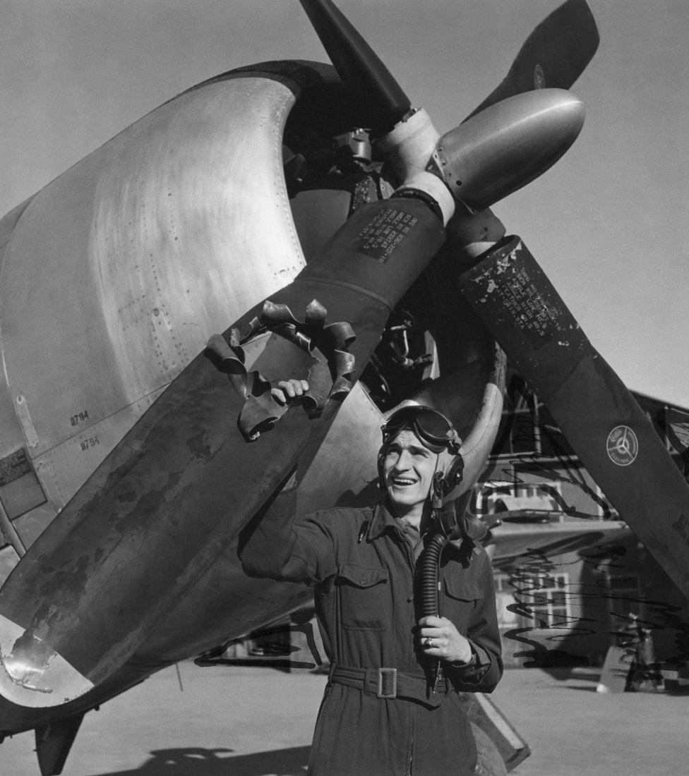 Lt Edwin Wright of the 404th Fighter Group, shows off the damage to his P-47 Thunderbolt, October 1944.